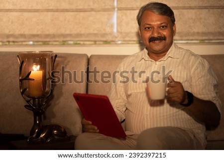 Businessman using digital tablet at home.

