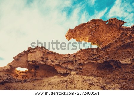 Duna Fosil de Los Escullos against cloudy sky. Rocky landscape Nature background