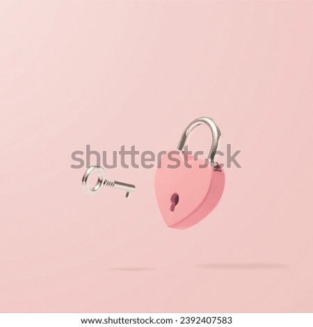 Heart-shaped pink padlock with  flying key on pastel background. Minimal Valentines Day, wedding or Mother's day concept. Creative love romantic emotion composition. Love messages for couples. Royalty-Free Stock Photo #2392407583