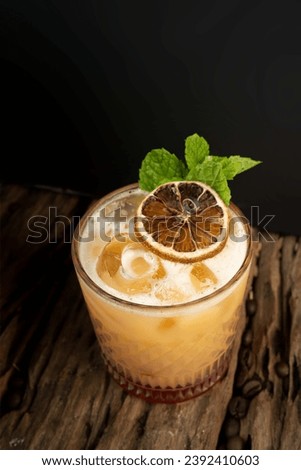 A visually pleasing Penicillin cocktail that combines the appeal of Scotch whiskey with the citrus flavor of fresh lemon juice and the soothing sweetness of honey syrup. Royalty-Free Stock Photo #2392410603