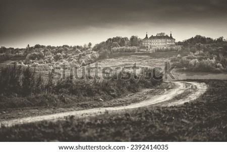village road in field and view to baroque palace on the hill in vintage style