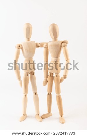 Wooden people hugging. People relationship concept. Friends.Wooden puppet Used for modeling human gestures. Royalty-Free Stock Photo #2392419993