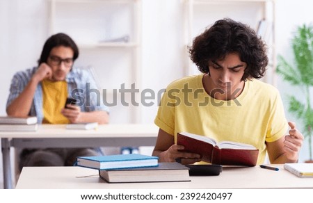 Two male students in the classroom Royalty-Free Stock Photo #2392420497