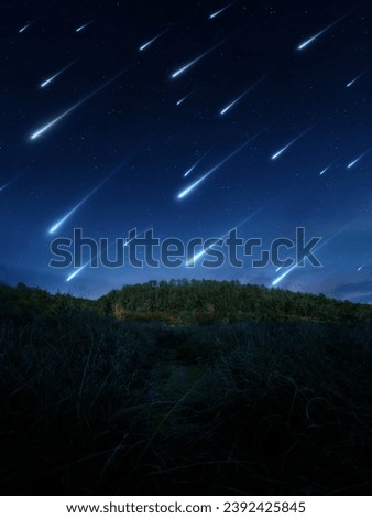 A stream of bright meteorites over a wooded hill. Night view of the sky with stars and comets. Starry nightscape.