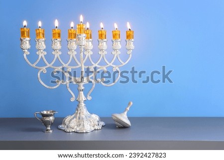 Religion image of jewish holiday Hanukkah background with menorah (traditional candelabra) and candles Royalty-Free Stock Photo #2392427823