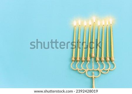 Religion image of jewish holiday Hanukkah background with menorah (traditional candelabra) and candles. Top view
