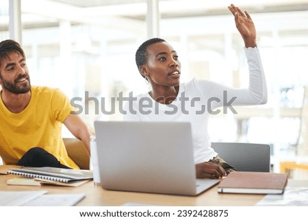 Ask more questions, gain more clarity. Shot of a young businesswoman raising her hand to ask a question during a meeting in a modern office. Royalty-Free Stock Photo #2392428875