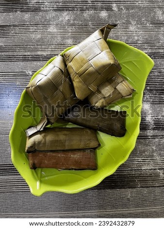 Rice cake , traditional food from Makasar, Indonesia. Buras made  from seamed rice wrapped with banana leaf. Ketupat is made from steamed rice wrapped with coconut leaves. Ketupat dan buras Royalty-Free Stock Photo #2392432879