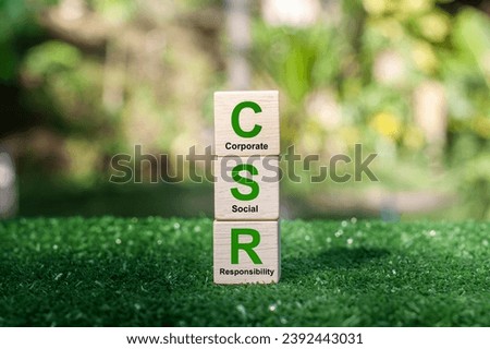 CSR Banner Business and Corporate Concept, Corporate Social Responsibility and Giving Back to Community, CSR icon on wooden block green background Royalty-Free Stock Photo #2392443031