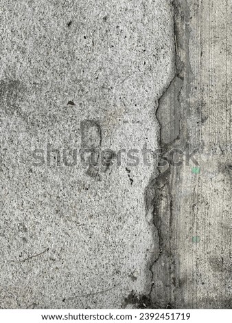 a footprint in the concrete.