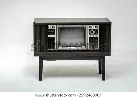 Retro old television with clipping path isolated on white background. TV stand and blank screen, with vintage radio and telephone, technology.
