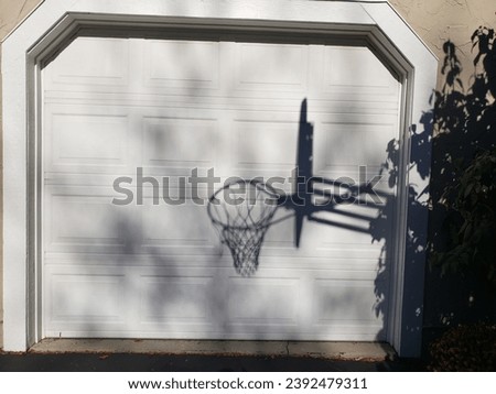 Shadow of a Basketball Goal on Garage Door