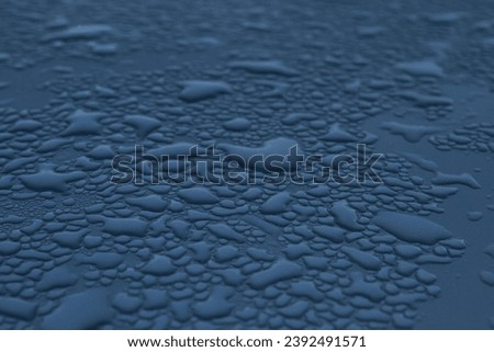 Raindrops on the surface in dark blue shades