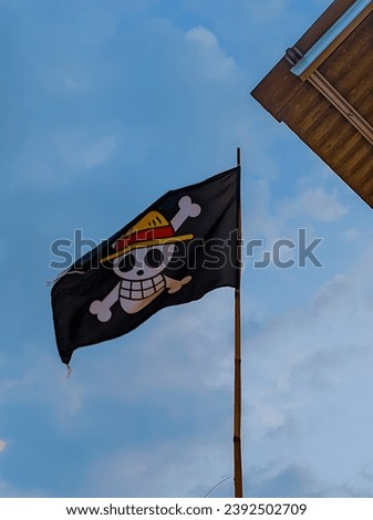 the flag flies against the bright blue sky