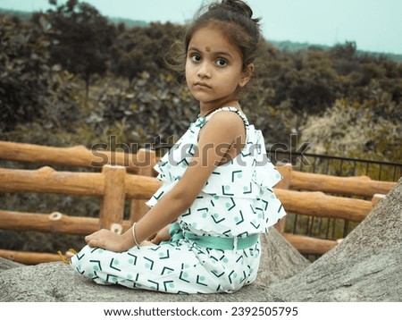 Ai different filter editing portrait image.Cute little girl standing on hill station.Wearing white cloth and keep smiling.