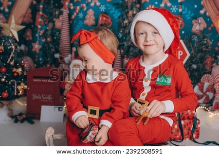 brother and sister in santa claus costume, boy and girl in red clothes, happy, smile, new year, christmas 