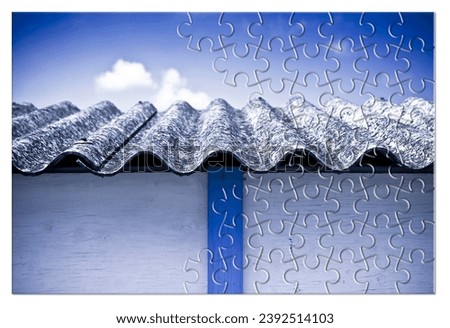 Asbestos removal  - Solution concept with an old asbestos roof panels in jigsaw puzzle shape Royalty-Free Stock Photo #2392514103