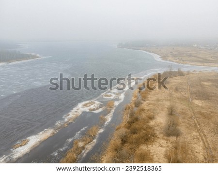 Fog on the ice river in spring from a bird's-eye view