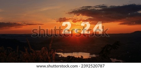Happy New Year greeting card 2024, Silhouette number of 2024 letters on the mountain with sunset on mountains landscape in twilight time. Starting to New Year concept