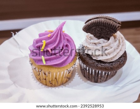 selective focus picture of two different types of small cupcakes 