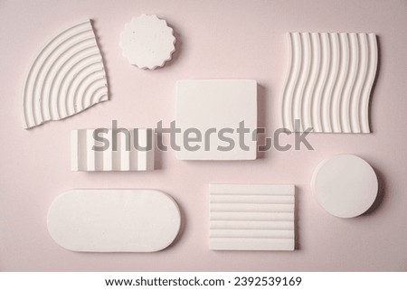 Decorative plaster podiums on pastel pink background, top view, flat lay. Place for product presentation. Creative product platform