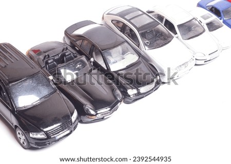 parking toy cars in a row top view isolated on white background.