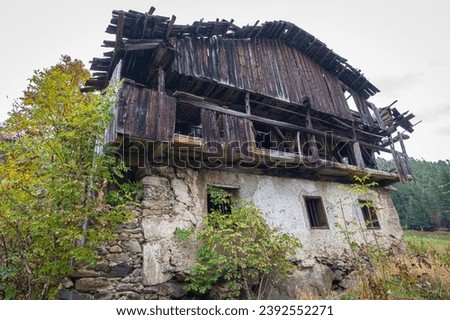 Poor sight of a dilapidated house in the European Alps Royalty-Free Stock Photo #2392552271