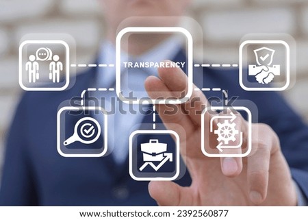 Man using virtual touch screen presses word: TRANSPARENCY. Concept of business transparency. Honest and clean company. Financial and economical stats sharing, publication and presentation. Royalty-Free Stock Photo #2392560877