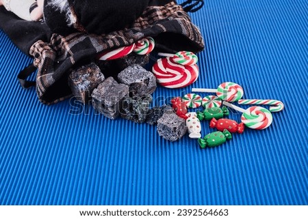 The Befana with sweet coal and candy. Italian Epiphany day tradition. Royalty-Free Stock Photo #2392564663
