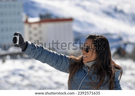 Young man taking a selfie in the mountains of sierra nevada, in the ski resort of granada.,