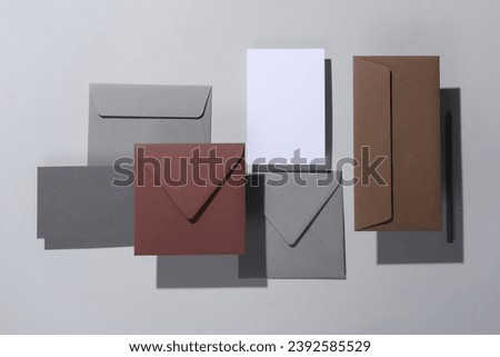 Floating envelopes and card on gray background with shadow. Minimalism, modern business still life, creative layout
