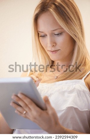 Woman, tablet and research for online communication, networking or social media in living room at home. Female person or blonde in relax on technology for search, reading or ebook in lounge at house