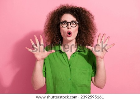 Photo portrait of pretty young girl raise hands excited boo exclaim dressed stylish green outfit isolated on pink color background