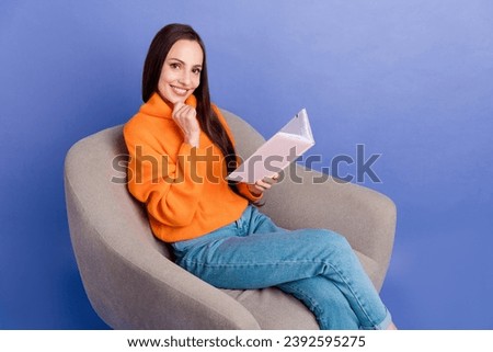 Photo of intellectual lady sit armchair touch chin turning pages reading planner control payment bills isolated on purple color background