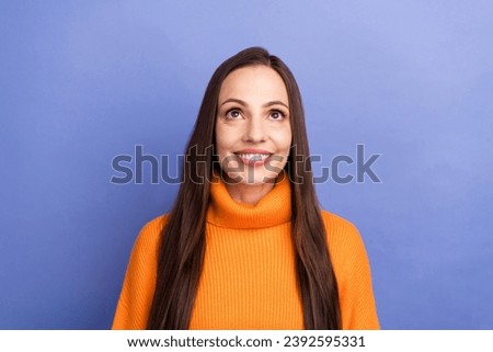 Photo of mature age woman in orange sweater looking above head smart idea for future moms save money isolated on violet color background