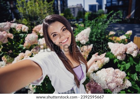 Photo of adorable sweet cute cheerful girl live streaming blog vlog walking botanical garden spring weather outdoors