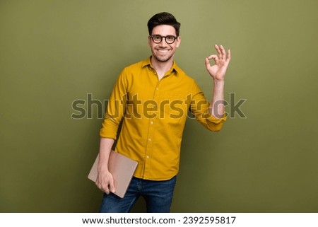 Photo of satisfied nice man it specialist geek wear yellow trendy clothes recommendation okey sign isolated on khaki color background Royalty-Free Stock Photo #2392595817