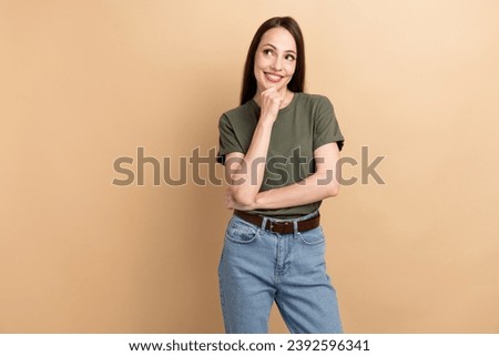 Portrait of intelligent business smiling lady touch chin looking empty space brainstorming process isolated on beige color background Royalty-Free Stock Photo #2392596341