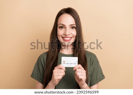 Photo of mature banking for business owners woman holding debit card presentation for rich users isolated on beige color background