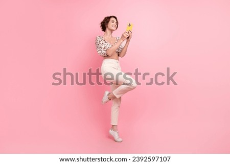 Full size photo of satisfied nice girl dressed stylish blouse white look at smartphone read email isolated on pink color background