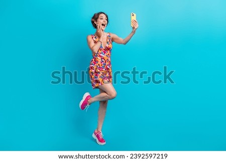Full size photo of astonished ecstatic woman dressed colorful clothes making selfie palm on cheekbone isolated on blue color background