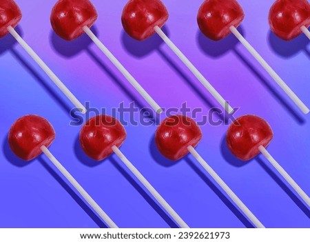 Array of Shiny Red Lollipops on a Saturated Blue Backdrop - Graphic Design Element for Confectionery Themed Events