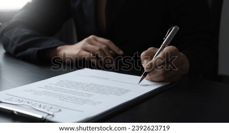 Close-up of the agreement document being signed. Business contract of young businesswoman