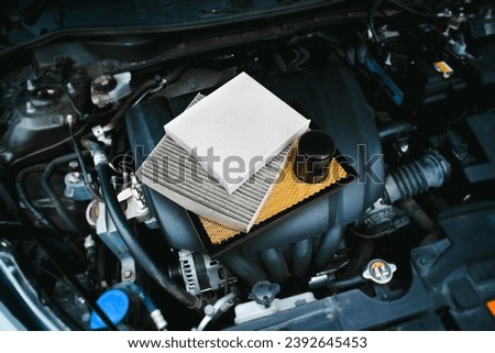 Car air filter and car oil filter on engine cover in engine compartment , Car spare parts concept Royalty-Free Stock Photo #2392645453