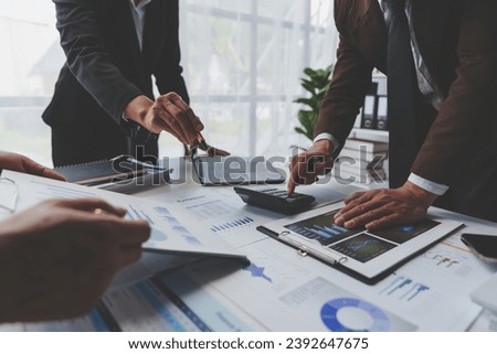 A group of Asian businessmen is meeting to summarize the company's operating results, finances, and profits and losses. Management of startup companies Growing Profitable Management Ideas.