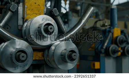 Industrial bender equipment machine for metal pipe bending in the factory. Creative. Automatic metalworking machine. Royalty-Free Stock Photo #2392651337