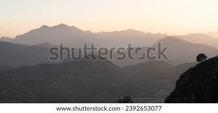 The beauty of the sunset over the rolling hills in the Himalaya Foothills of Nepal. Royalty-Free Stock Photo #2392653077