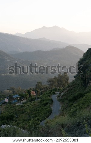 The beauty of the sunset over the rolling hills in the Himalaya Foothills of Nepal. Royalty-Free Stock Photo #2392653081