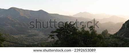 The beauty of the sunset over the rolling hills in the Himalaya Foothills of Nepal. Royalty-Free Stock Photo #2392653089