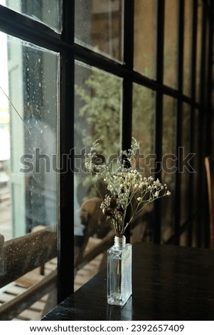 cafe interior French style vase with gypsophila on the table stained glass